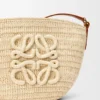 Eclipse-pochette i raffia och kalvskinn Eclipse-pochette i raffia och kalvskinn